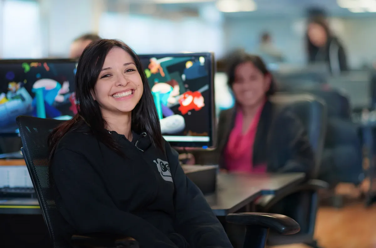 DEVBOT team members at their desks in the studio